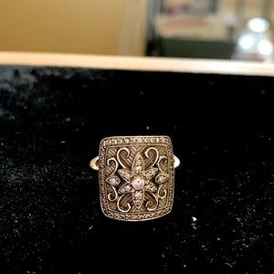 14k white and rose gold ring filled with diamonds.